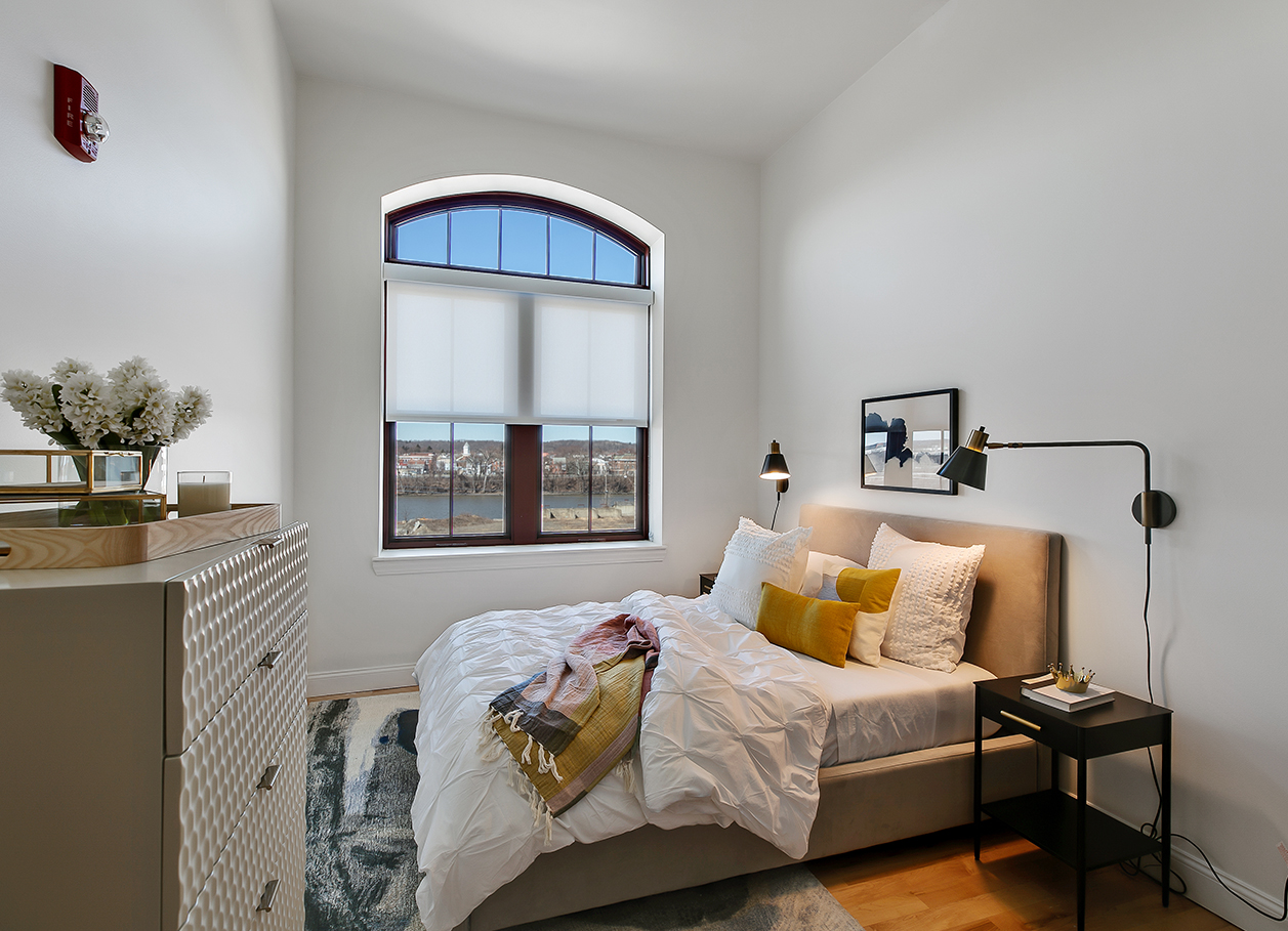 Photo of a furnished bedroom area in an apartment at 2 River Street.