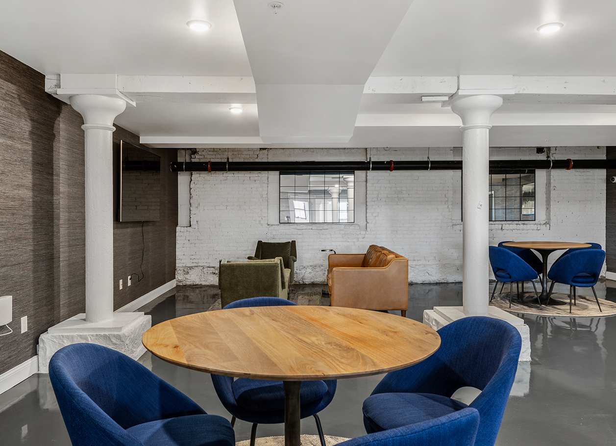 Photo of tables and chairs in the lounge area at 2 River Street.