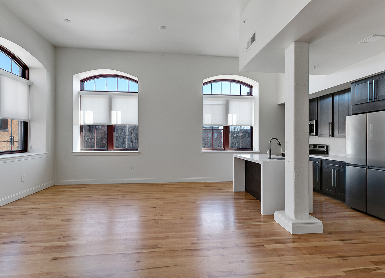 Photo of the open floorplan kitchen area of an apartment at 2 River Street.