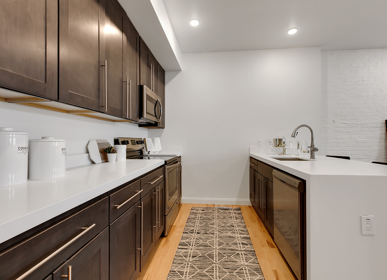 Photo looking between the counters in the kitchen area of an apartment at 2 River Street.