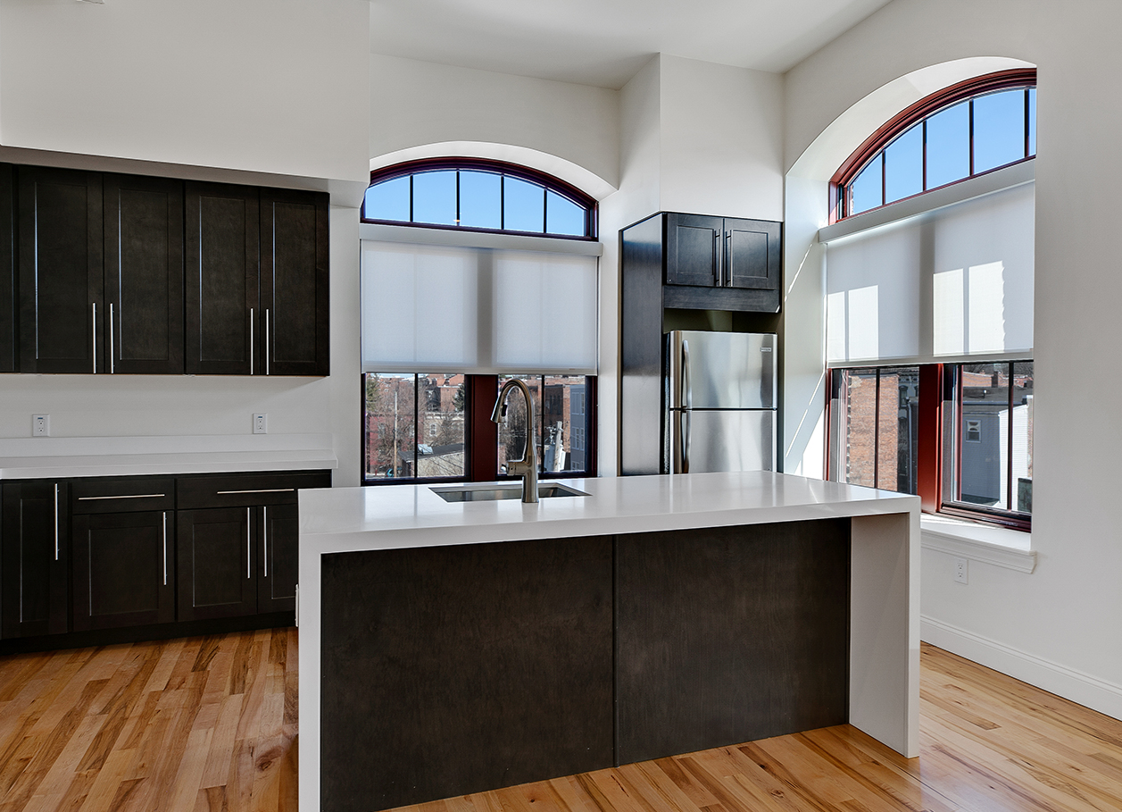 Photo of an apartment with a large kitchen area and corner windows at 2 River Street.